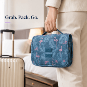 Traveller carrying a folded toiletry pouch beside luggage